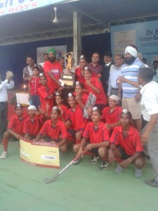Hockey team of Baba Gurmukh Singh Uttam Singh Senior Secondary School with winners' trophy